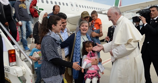 Pope Francis welcomes a group of Syrian migrants at Rome's Ciampino airport on April 16, 2016 following a visit to the Greek island of Lesbos.