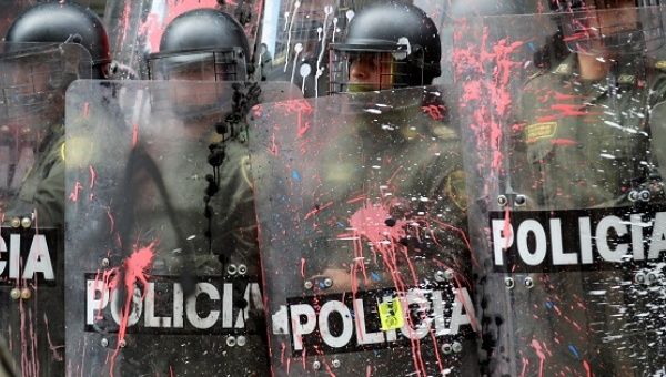 Riot police stand on guard during a demonstration in Bogota, Colombia, March 17, 2016.