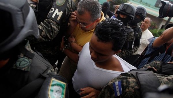 Military police escort two suspects arrested in connection with the killing of Berta Caceres upon their arrival to a hearing at a court in Tegucigalpa, May 6, 2016. 