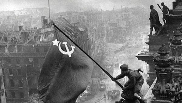 Soviet soldiers raise the flag on the roof of the Reichstag building in Berlin in this archive photo, May, 1945.