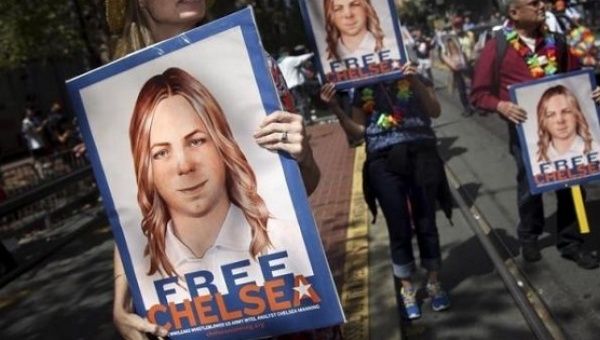 People hold signs calling for the release of imprisoned WikiLeaks whistleblower Chelsea Manning in San Francisco, California June 28, 2015.
