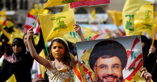 Hezbollah supporters hold posters of group's leader Hassan Nasrallah.