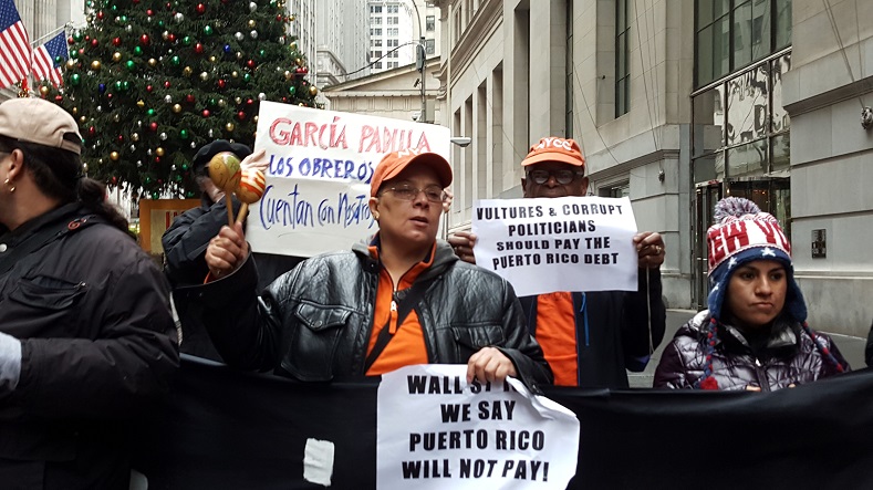 Puerto Ricans protest on Wall Street, blaming U.S. imperialism for the debt crisis. 