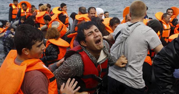 A Syrian refugee cries while disembarking from a flooded raft at a beach on the Greek island of Lesbos, after crossing a part of the Aegean Sea from the Turkish coast on an overcrowded raft, Oct. 20, 2015.