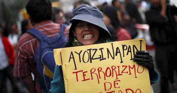 A demonstrator holds a sign alleging state terrorism during a protest against the government’s handling of the missing students in Mexico City last month.