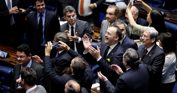 Members of Brazil's Senate react after a vote to remove President Dilma Rousseff from office in Brasilia, Brazil, May 12, 2016.