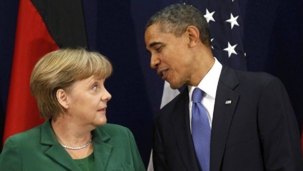 U.S. President Barack Obama speaks with German Chancellor Angela Merkel