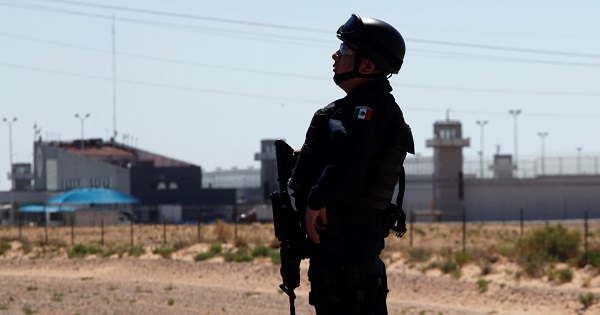 A federal police officer stands near a prison in Ciudad Juarez where Mexican drug boss Joaquin 