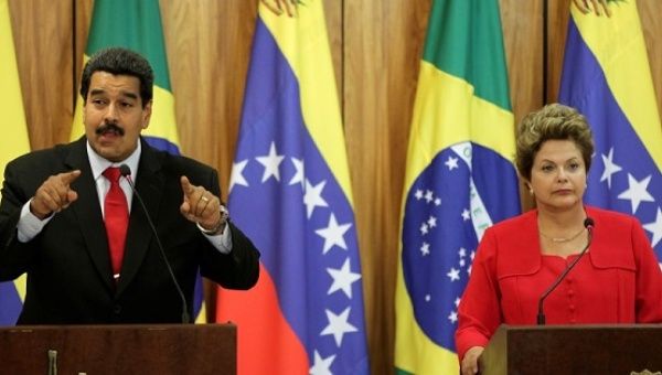 Venezuelan President Nicolas Maduro delivers a statement to the media with his Brazilian colleague Dilma Rousseff at the Planalto Palace in Brasilia.