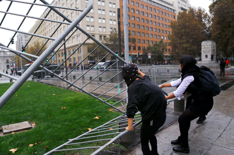 Student protesters remove a barrier during a demonstration to demand changes in the education system in Santiago.