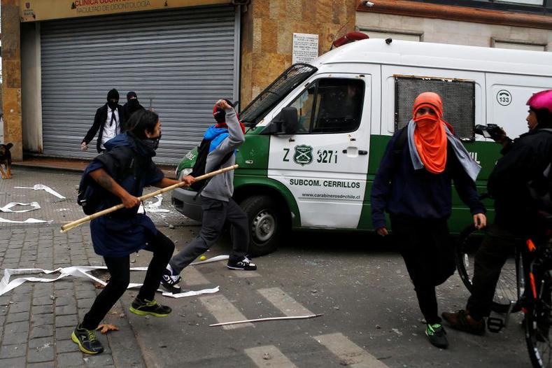 Student protesters clash with the police during a demonstration to demand changes in the education system in Santiago.