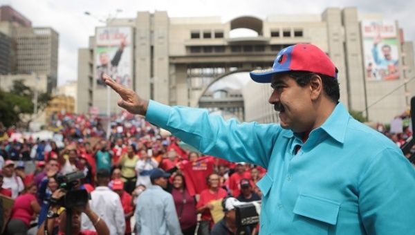 Venezuelan President Nicolas Maduro waves to a crowd that had assembled to show support for emergency measures announced by the government, Caracas, Venezuela, May 14, 2016.