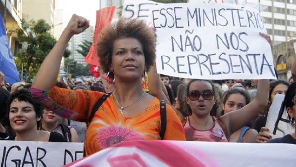 Brazilian women protest against the Senate-imposed government of Michel Temer with a sign reading 