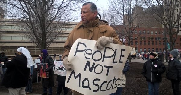 Native Americans protest the use of the racial slur as a football team's name.