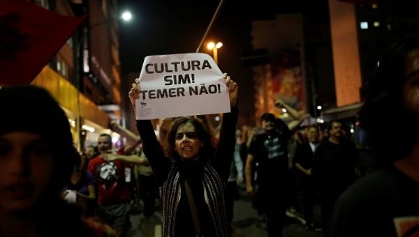 A woman holds a sign during a protest against Brazil's interim President Temer in Sao Paulo.