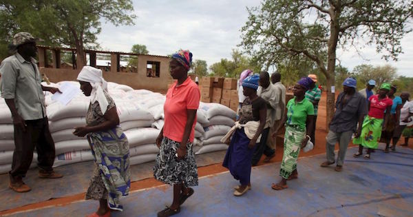 Villagers collect their monthly food ration provided by the United Nations World Food Program in Masvingo, Zimbabwe.