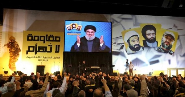 Hezbollah leader Sayyed Hassan Nasrallah addresses supporters through a giant screen during a rally in Beirut's southern suburbs, Lebanon Feb. 16, 2016.