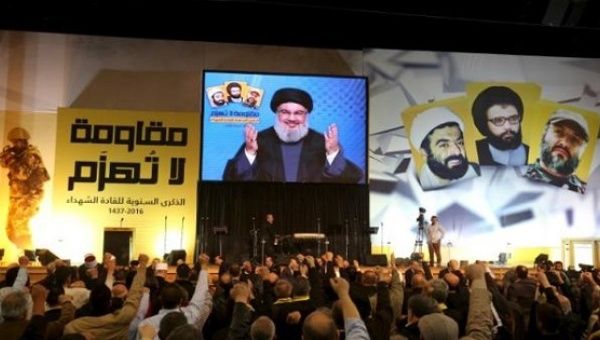 Hezbollah leader Sayyed Hassan Nasrallah addresses supporters through a giant screen during a rally in Beirut's southern suburbs, Lebanon Feb. 16, 2016.