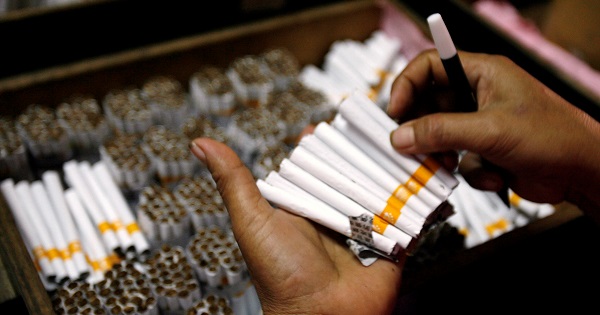 An employee packs cigarettes, Sidoarjo, Indonesia's East Java province April 7, 2010.