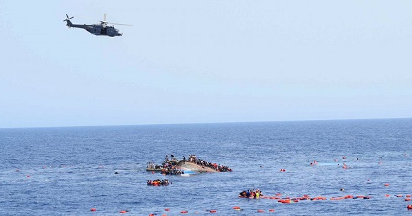 Italian navy ships rescue people from the overturned boat