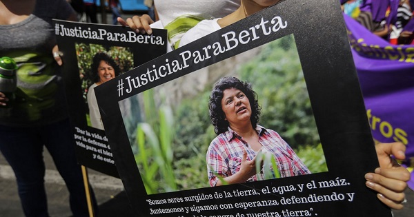 Demonstrators carry signs demanding justice for murdered Honduran environmental leader Berta Caceres.