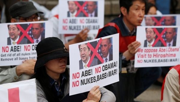 Protesters hold placards at the Peace Memorial Park in Hiroshima.