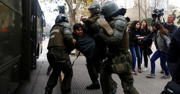 A demonstrator is detained during an unauthorized march called by secondary students to protest against government education reforms in Santiago, Chile, May 26, 2016.