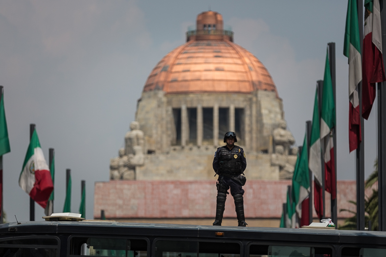 Protesters marched Friday in central Mexico City as authorities deployed thousands of officers to safeguard monuments. 
