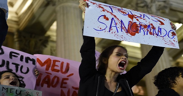 Brazilians protest in front of the Legislative Assembly of Rio de Janeiro on Friday against an alleged gang rape that police say they are investigating.