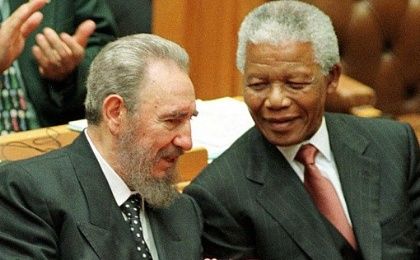 Cuban President Fidel Castro chats with President Nelson Mandela after addressing the South African Parliament on September 4, 1998.