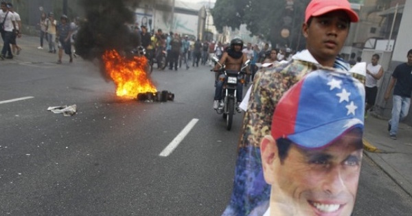 A man holds a poster of Henrique Capriles in protest of Maduro's election as president on April 2013.