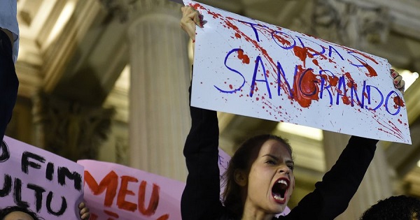 Brazilians protest in front of the Legislative Assembly of Rio de Janeiro on Friday against an alleged gang rape that police say they are investigating.