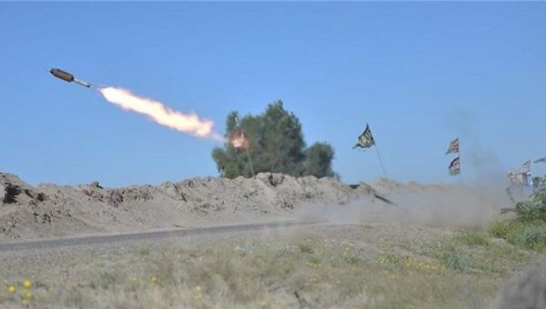 Iraqi fighters fire a rocket towards Islamic State group positions on the outskirts of Fallujah.
