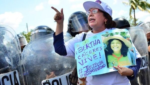 A woman marches to demand justice for murdered Honduran Indigenous leader Berta Caceres on International Women's Day.