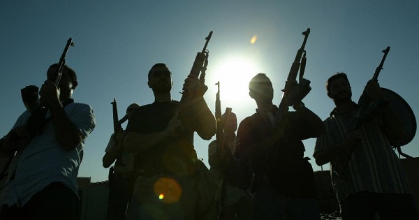 Members of U.S. private security company Blackwater pose on the rooftop of a house in Baghdad, September 2007.