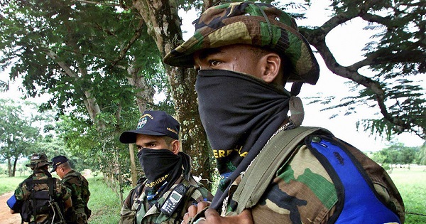 Paramilitary agents of the AUC stand armed in Colombia.