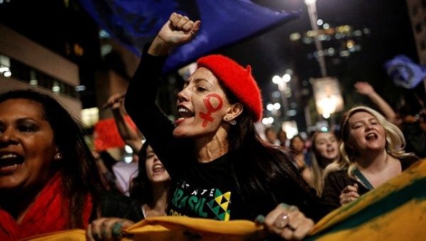 Women shout slogans during a protest against Brazil's interim President Michel Temer and in support of President Dilma Rousseff in Sao Paulo.
