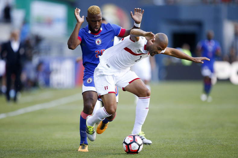 Peru defender Alberto Rodriguez (2) gets pushed down by Haiti forward Duckens Nazon (20) during the first half of the group play stage of the 2016 Copa America Centenario at Century Link Field.