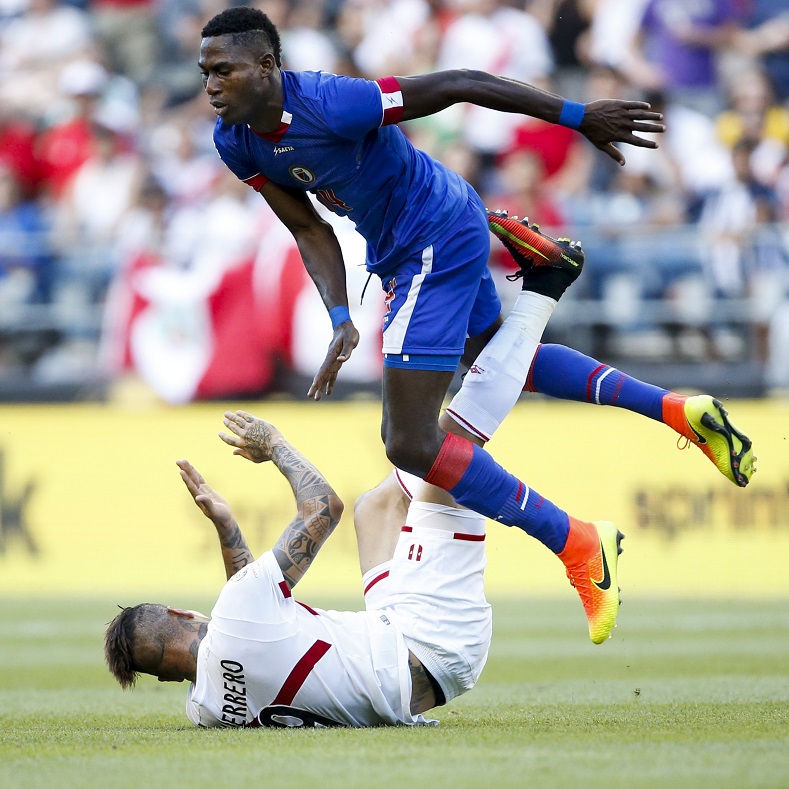 Haiti midfielder Sony Norde (14) goes up and over Peru forward Jose Paolo Guerrero (9) during the second half of the group play stage of the 2016 Copa America Centenario at Century Link Field. 