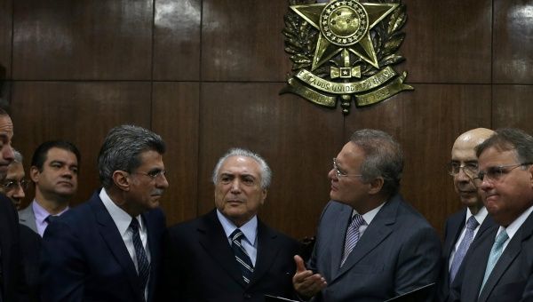 Brazil's interim President Michel Temer (C) attends a meeting with Brazil's Senate President Renan Calheiros (centre, R) and Planning Minister Romero Juca (centre, L) in Brasilia, Brazil, May 23, 2016.