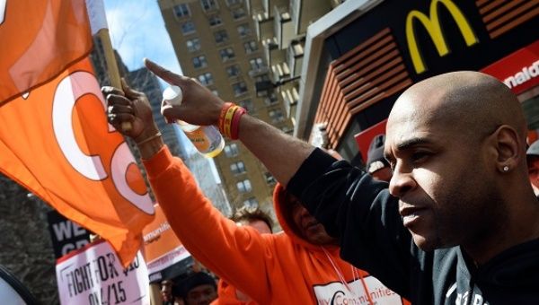 Protesters gather outside a McDonald's restaurant to 'Fight for $15′ increase in pay wage on April 15, 2015 in NYC. 