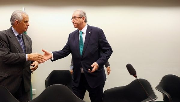 Cunha (R) greets president of ethics committee during his defense, in Brasilia
