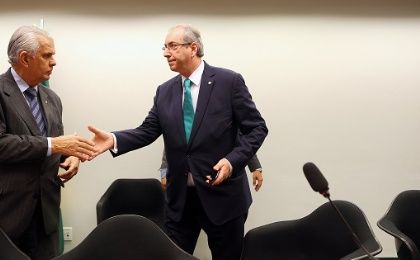 Cunha (R) greets president of ethics committee during his defense, in Brasilia