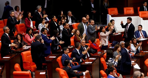 Pro-Kurdish opposition Peoples' Democratic Party (HDP) MPs react after Turkey's parliament approved a bill to lift lawmakers' immunity from prosecution, at the Turkish parliament in Ankara.