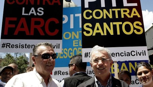 Alvaro Uribe (R) during a march against peace with the FARC.