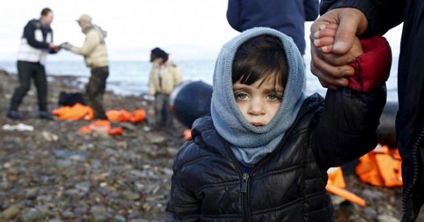 A Syrian refugee child looks on, moments after arriving on a raft with other Syrian refugees on a beach on the Greek island of Lesbos, January 4, 2016.