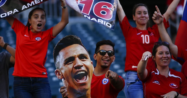 Chile fans hold up a picture of Alexis Sanchez.