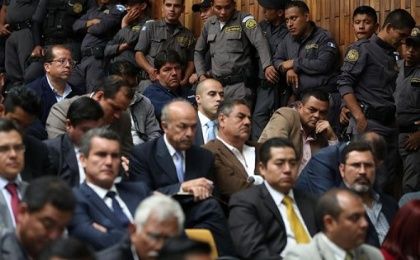 Security personnel guard the accused in the State Cooptation case in court in Guatemala City, June 14, 2016.