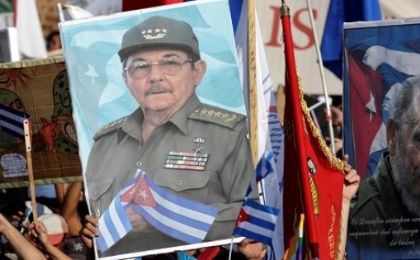 People carry pictures of Cuba's president Raul Castro and his brother and Cuba's former President Fidel Castro during a parade in Havana