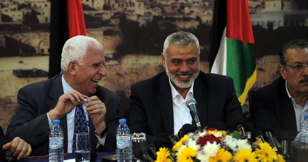 Palestinian Fatah delegation chief Azzam al-Ahmed (L) laughs with Hamas prime minister in the Gaza Strip Ismail Haniyeh during previous reconciliation talks.